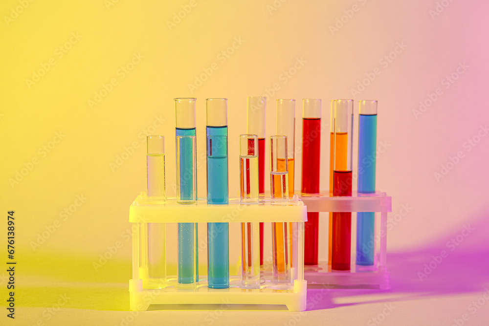 Test tubes with different samples in stands on colorful background Test tubes with different samples in stands on colorful background