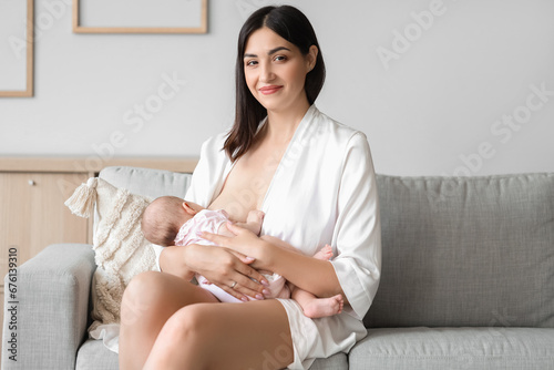 Smiling young mother breast...