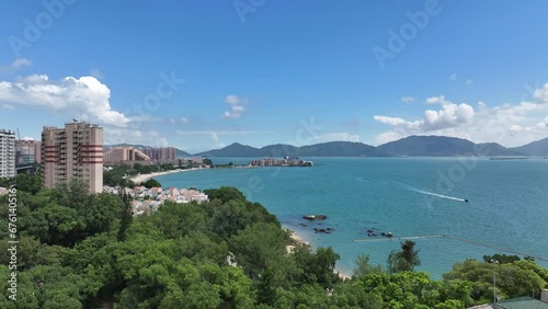 Aerial drone skyview of Castle Peak Road near Hong Kong Gold Coast Beach , So Kwun Wat, Tuen Mun, New Territories, is an idyllic convenient seaside and mountain area that includes a yacht club, countr photo