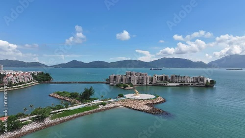 Aerial drone skyview of Castle Peak Road near Hong Kong Gold Coast Beach , So Kwun Wat, Tuen Mun, New Territories, is an idyllic convenient seaside and mountain area that includes a yacht club, countr photo