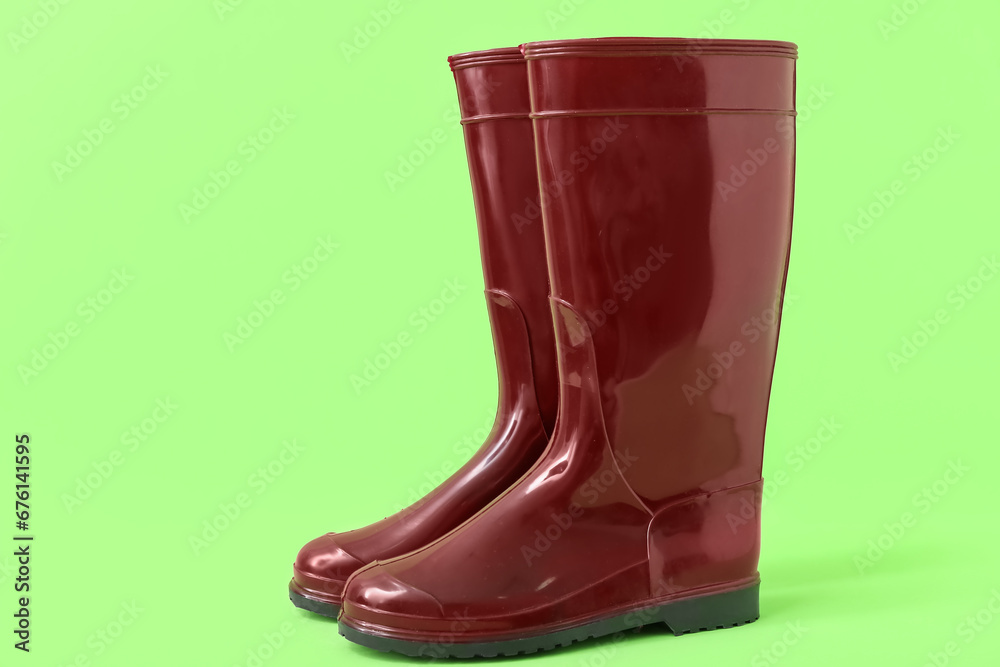 Red gumboots on green background Red gumboots on green background