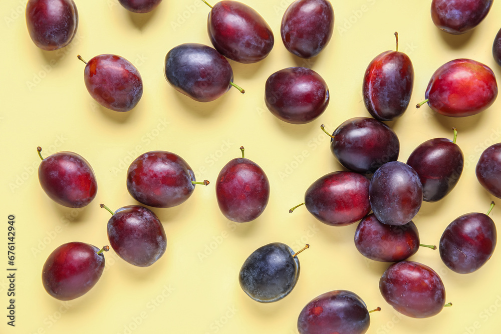 Fresh ripe plums on yellow background Fresh ripe plums on yellow background