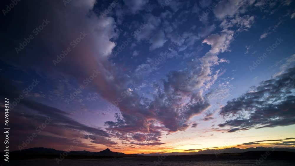 Holy Grail timelapse from day to night during colorful sunset over the Utah desert.