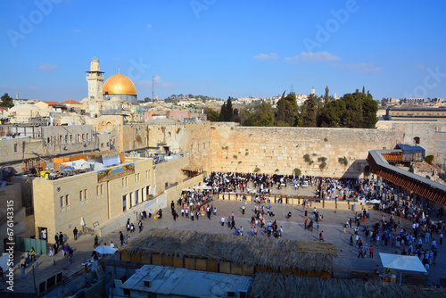 People pray a the Western Wall, Wailing Wall or Kotel the Place of Weeping is an ancient limestone wall in the Old City of Jerusalem. Second Jewish Temple by Herod the Great photo