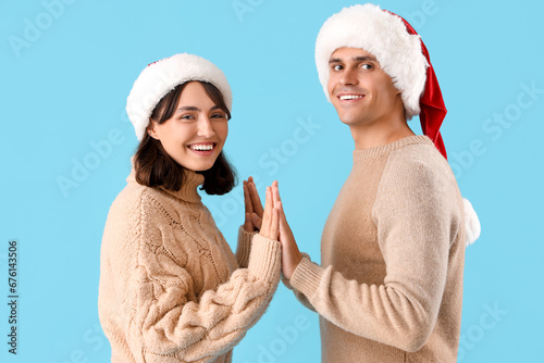 Happy young couple in santa...