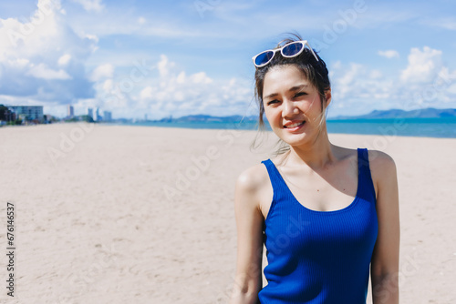 Portrait of asian woman feeling hot and burn from the sun on sunny beach.