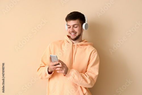 Young bearded man in headph...