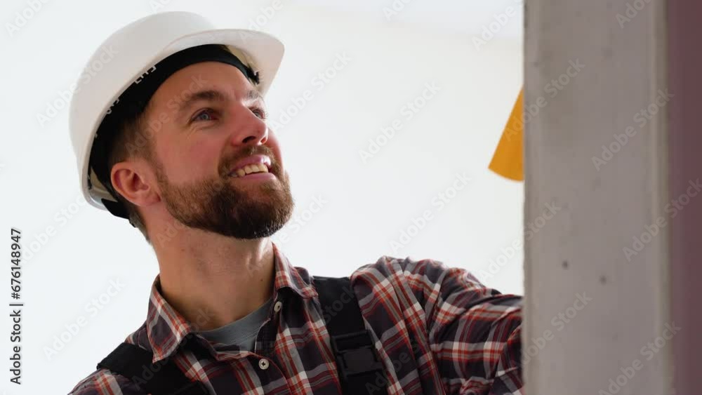 Worker painting a wall in new apartment Worker painting a wall in new apartment