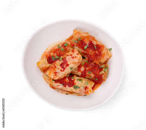 Plate of delicious stuffed cabbage rolls cooked with homemade tomato sauce isolated on white, top view