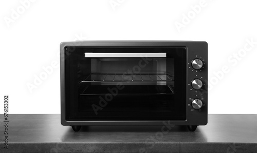 One electric oven on grey table against white background