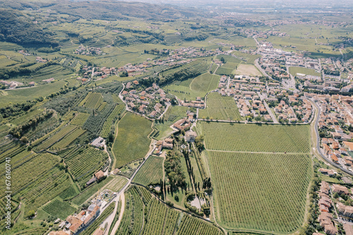Commune of Negrar Valpolicella with green vineyards in a mountain valley. Italy. Drone