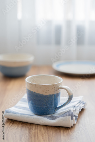Vintage of blue and white cup with napkin on wood table
