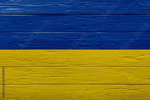National flag of Ukraine painted on wooden surface