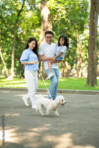 Photo of young Asian family at park