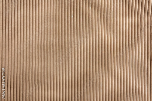 Tan corduroy fabric, closeup of surface material texture photo