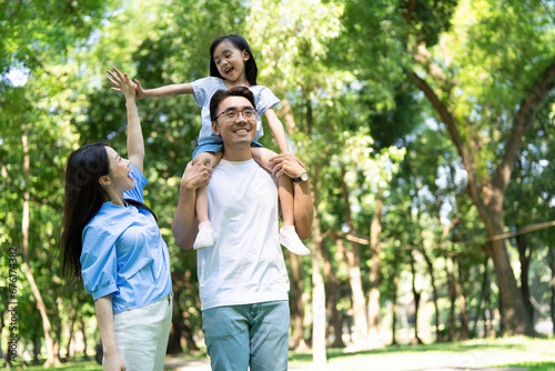 Photo of young Asian family at park