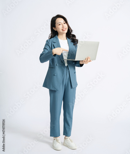 Image of young Asian business woman on background