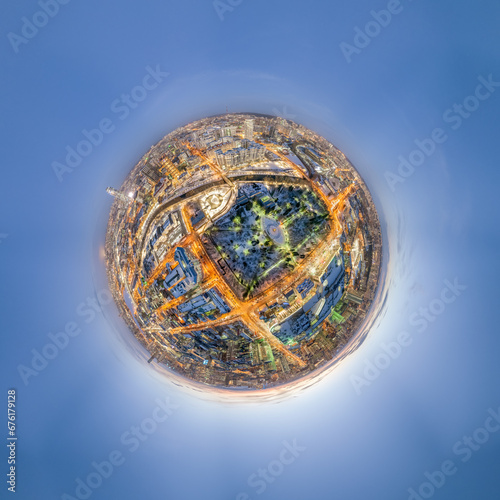 Aerial winter city view with crossroads and roads, houses, buildings, parks and bridges. Copter shot. Little planet sphere mode.