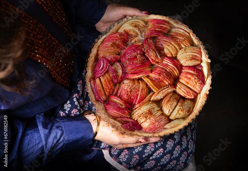 A woman holding an apple pie  photo