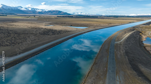 Aerial view of the Pukaki hydro power scheme canal in rural Twizel running in parallel with the now capped Ben Ohau mountain range photo