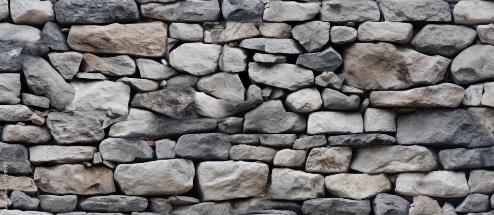The old stone wall with its natural rock structure lends a unique and timeless appeal to the background of the abstract pattern while showcasing the design inspired by nature and textures fo The old stone wall with its natural rock structure lends a unique and timeless appeal to the background of the abstract pattern while showcasing the design inspired by nature and textures fo