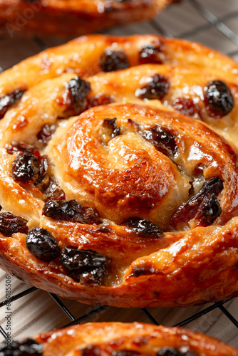 Pain aux raisins, also called escargot or pain russe, is a spiral pastry often eaten for breakfast in France. Its names translate as raisin bread, snail, and Russian bread respectively. photo