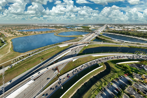 Aerial view of american highway junction with fast driving vehicles in Miami, Florida. View from above of USA transportation infrastructure