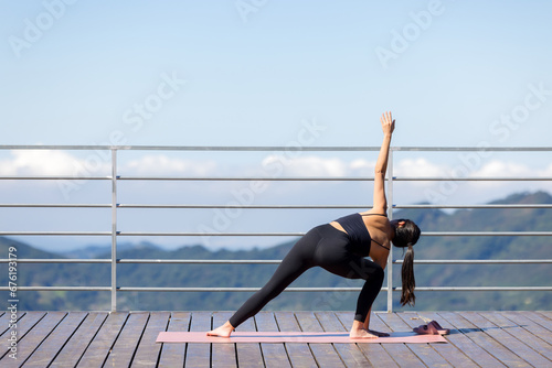 Woman wear sportwear and do yoga at nature mountain photo