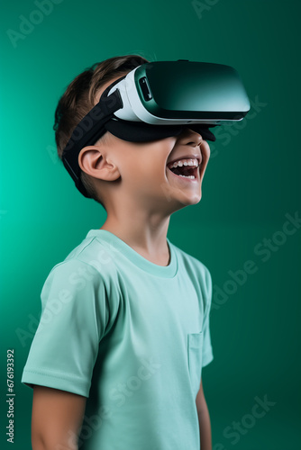 Young boy getting experience using VR headset glasses isolated on a green background