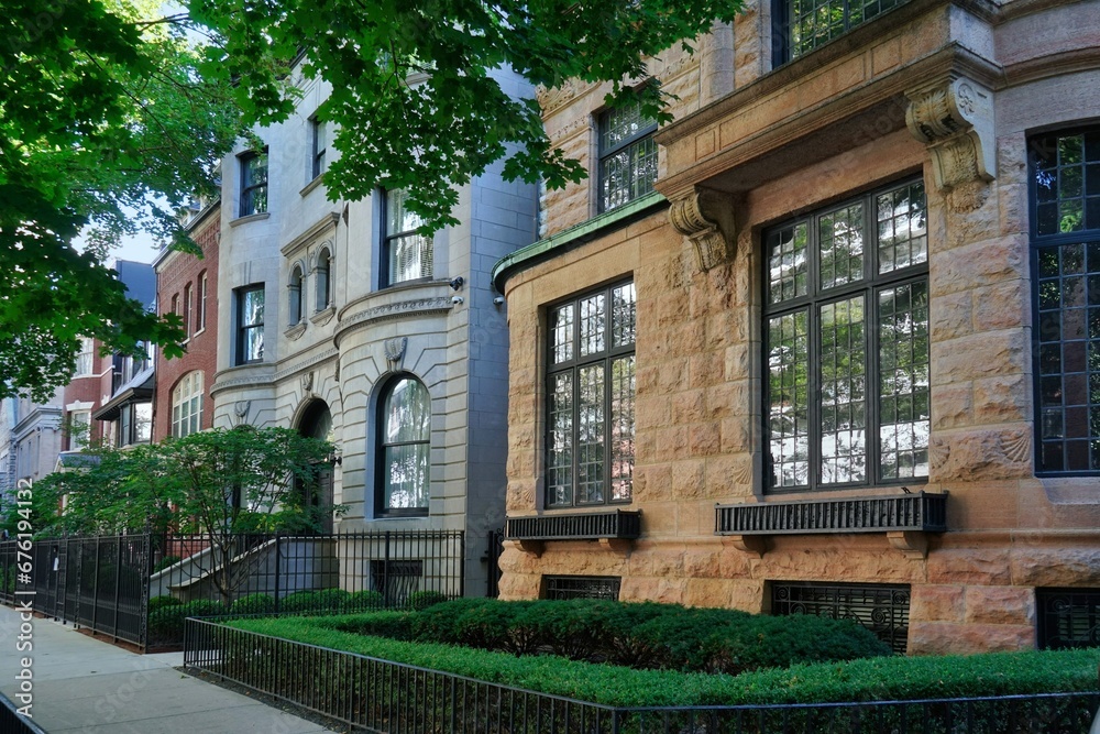 Row of ornate old 19th century townhouses with small front garden