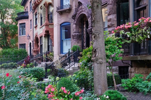 Row of ornate old 19th century townhouses with small front garden