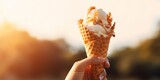 Woman's hands holding melting ice cream waffle cone in hands on summer light nature background : Generative AI