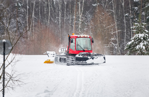 A snowcat grooms a road for the ski tracks in the city park