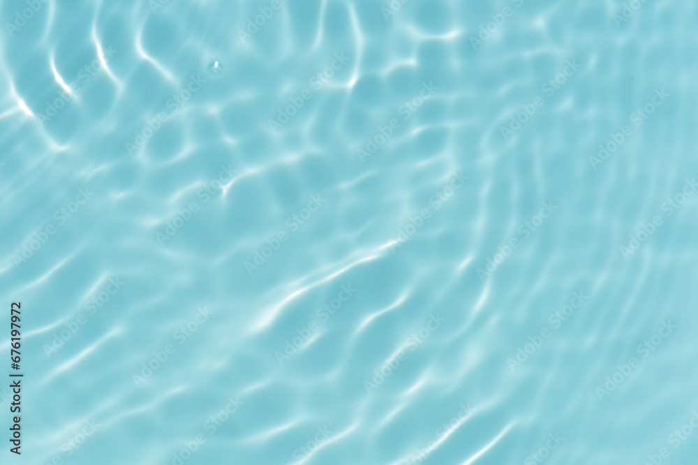Defocus blurred transparent blue colored clear calm water surface texture with splashes reflection. Trendy abstract nature background. Water waves in sunlight with copy space. Blue watercolor shine. Defocus blurred transparent blue colored clear calm water surface texture with splashes reflection. Trendy abstract nature background. Water waves in sunlight with copy space. Blue watercolor shine.