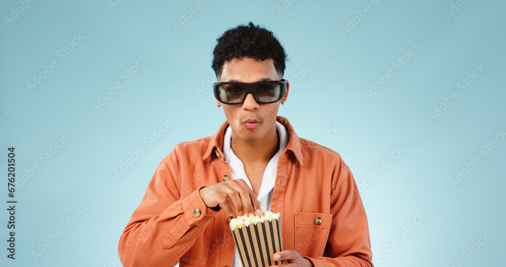 Man popcorn and studio with glasses for 3d movie with eating snack, streaming video and cinema by blue background. Person, sunglasses and corn fast food to watch show, cartoon and film in theater