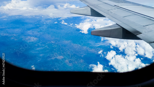 Clouds and sky through an airplane window. Aerial view background. Travel concept. traveler, trip, vacation, tourism, landscape, vibrant, nature, scenery