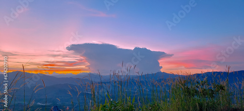 Large clouds that has a wonderful and beautiful shape Landscape mountain twilight sunset. Banner Nature colorful cloudy. Background horizons natural evening.Relax feeling time, freedom lifestyle rest