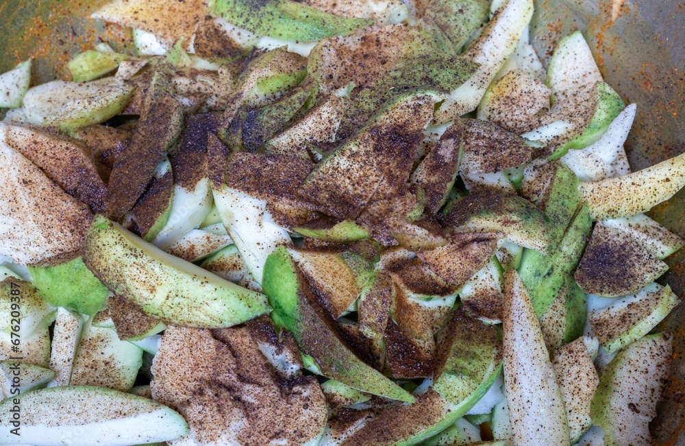 Raw Mango Cuts Marinated with Salt, Red Chili Powder, Black Pepper Powder and Turmeric Preparing for Mango Pickle Raw Mango Cuts Marinated with Salt, Red Chili Powder, Black Pepper Powder and Turmeric Preparing for Mango Pickle