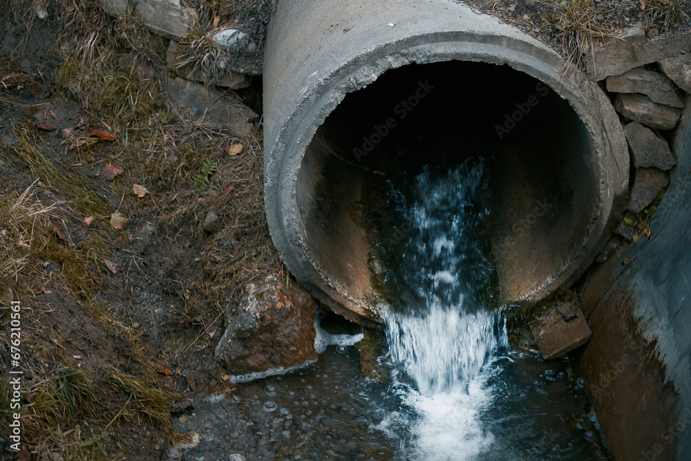 Draining sewage from a pipe into the river. Concept of pollution rivers ...