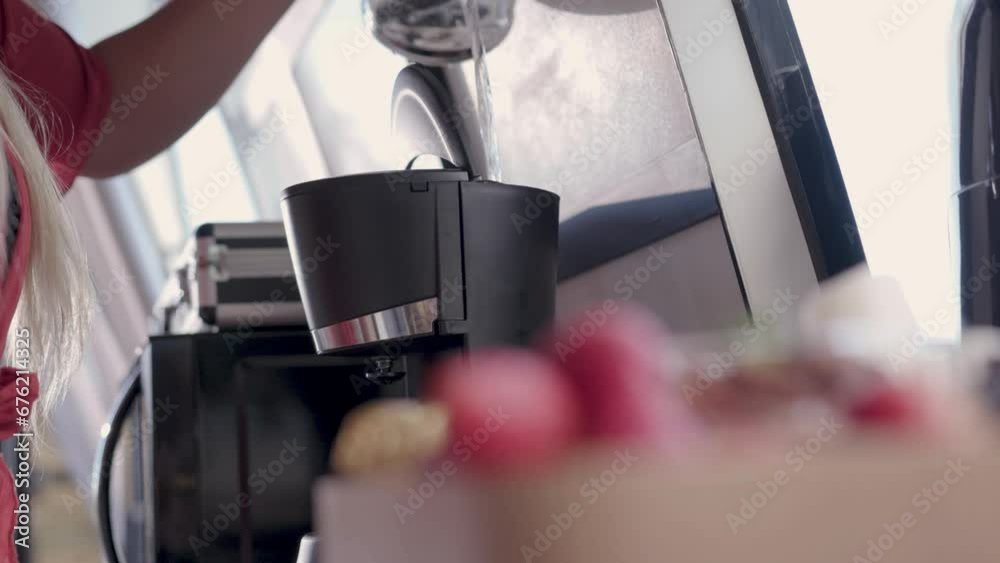 Close up of strawberries while a woman prepares coffee in the background Close up of strawberries while a woman prepares coffee in the background