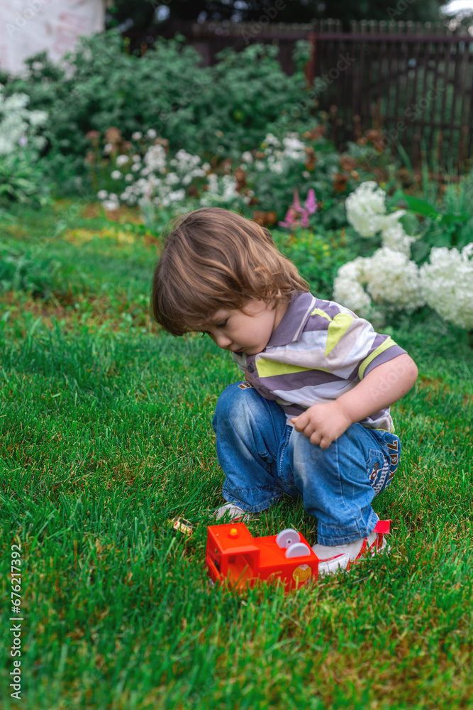 little boy in the summer garden little boy in the summer garden