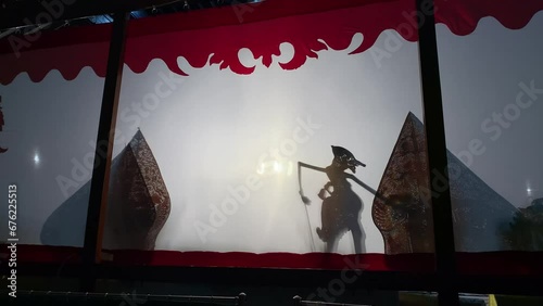 Silhouette of wayang kulit or shadow puppets from Java, Indonesia puppet show by dalang or puppeteer photo