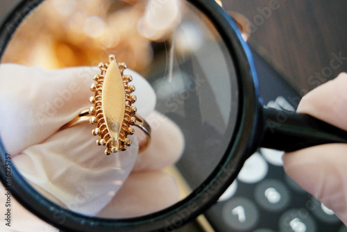 Wallpaper Mural Pawnshop worker verify jewellery on many golden and silver jewelleries and money background. Customers Buy and Sell Precious Metals, Jewels, Ancient Coins and Second Hand Appliances. Torontodigital.ca