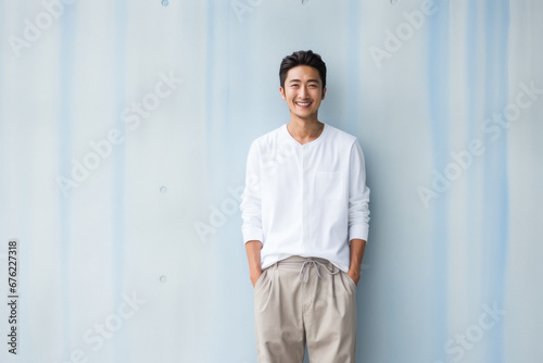 Young japanese man in white shirt and pant.