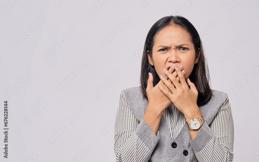 Surprised beautiful young Asian woman in casual clothes covering mouth with hand, looking at the camera with amazed facial expression isolated on white background. People lifestyle concept