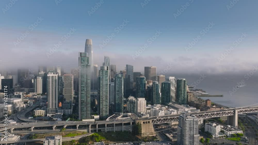Establishing shot of financial district of San Francisco skyscrapers. High rise buildings of business offices downtown. Aerial view of San Francisco city urban futuristic skyline in low heavy fog 4K