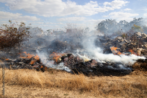 steppe fires during severe drought completely destroy fields. Disaster causes regular damage to environment and economy of region. The fire threatens residential buildings. Residents extinguish fire