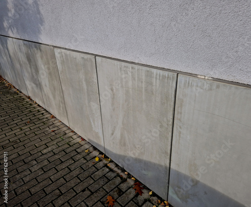 cladding of the house consists of concrete slabs with gaps with a ventilation grid protecting the insulation against mice and rodents. protection of the polystyrene facade from the pavement photo