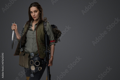 Canvas-taulu Middle Eastern descent in post-apocalyptic survival gear, brandishing a dagger o