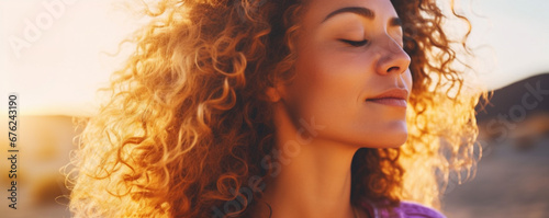 Close up sunset portrait of attractive woman with closed eyes and sun in back light, Dreaming and enjoying feeling concept lifestyle emotion, Serene female people outdoor with curly hair photo